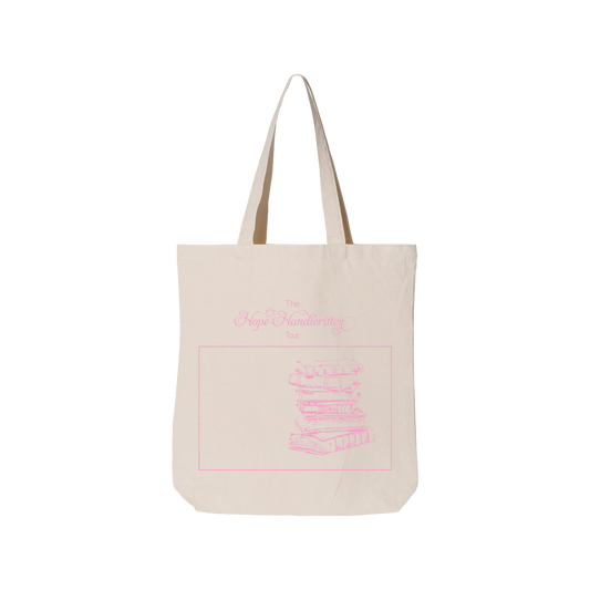 A natural colored cotton tote bag with pink text print on one side.