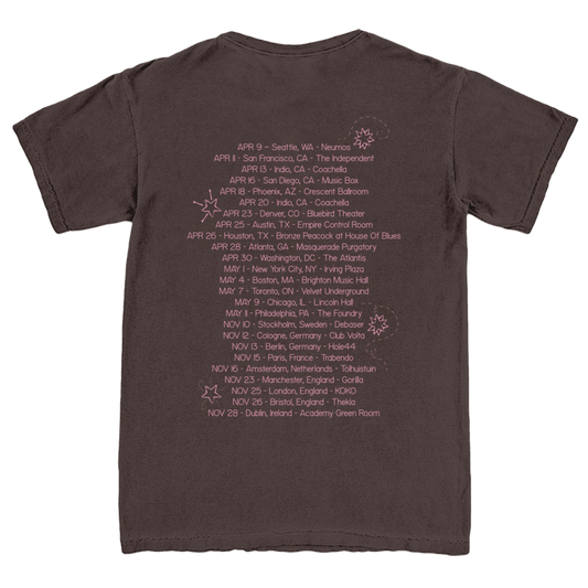Brown t-shirt with a list of dates and locations printed on the back.